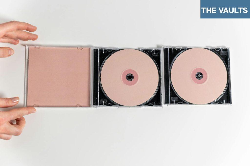 A Compact Discs on White Surface