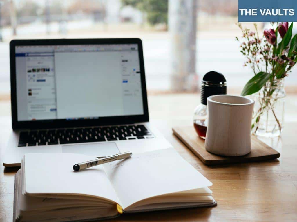 MacBook Pro near white open book