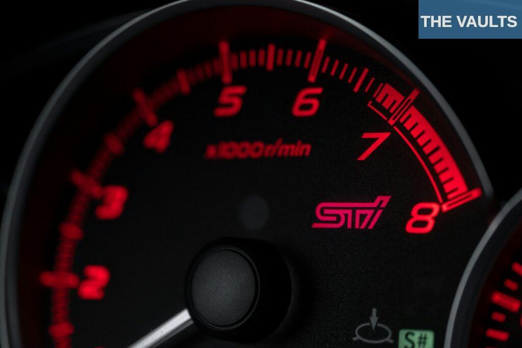 black and red speedometer at 0