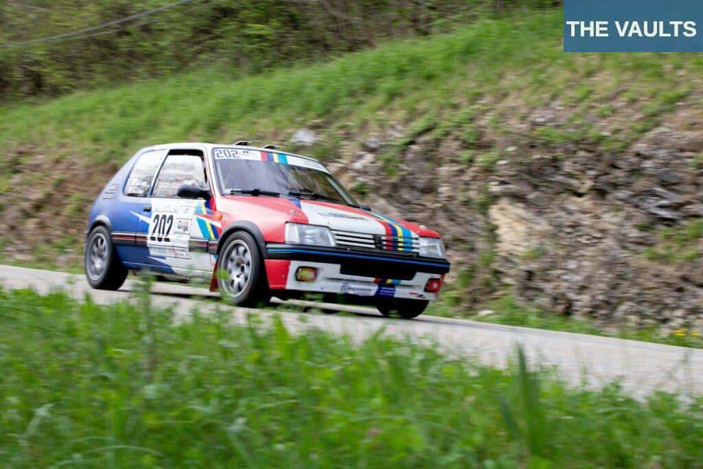 A Peugeot 205 Rally Car Driving Fast on the Road