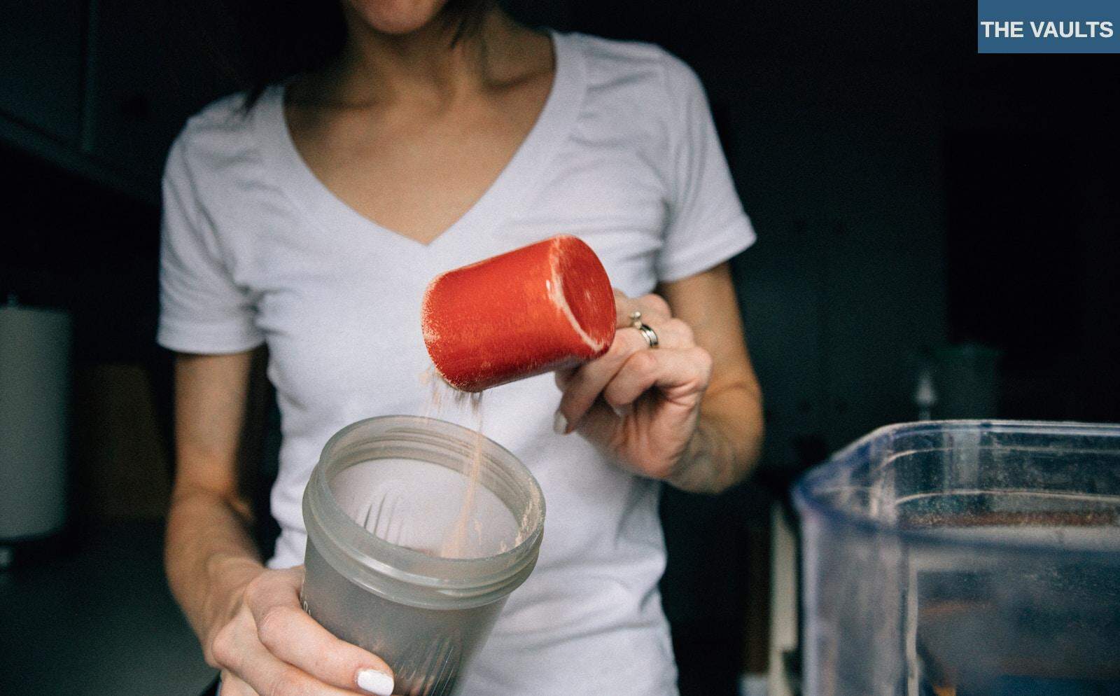 woman in white crew neck t-shirt holding red plastic cup