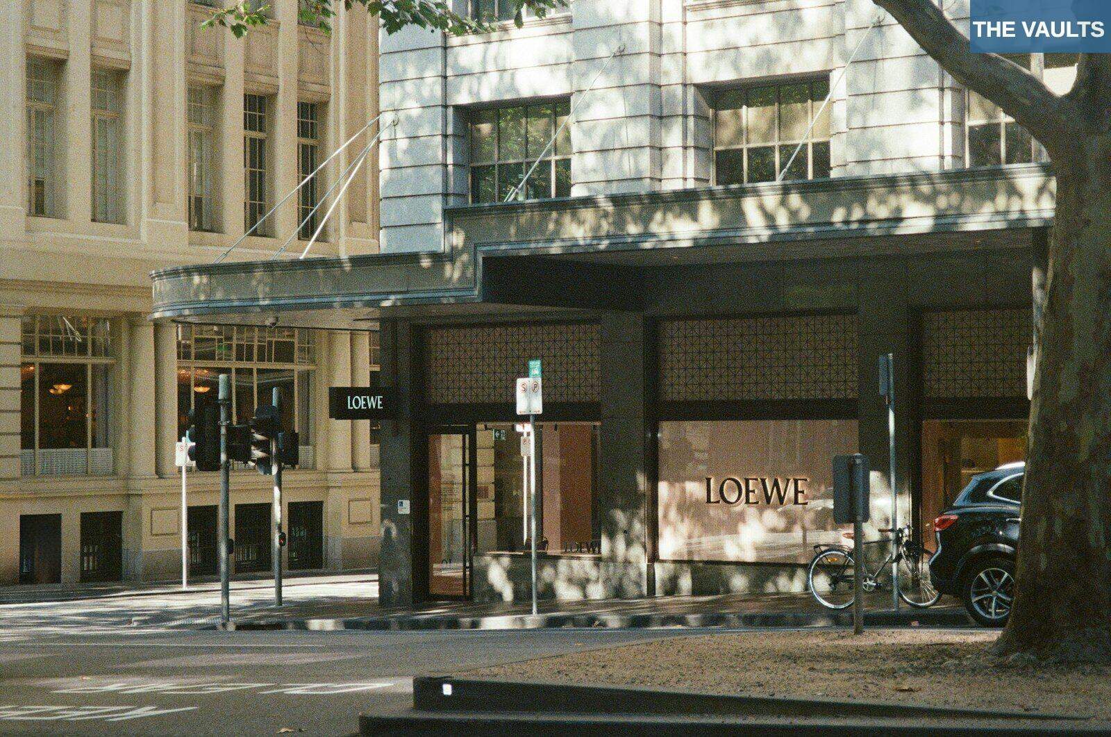 Storefront with loewe logo on a city street.